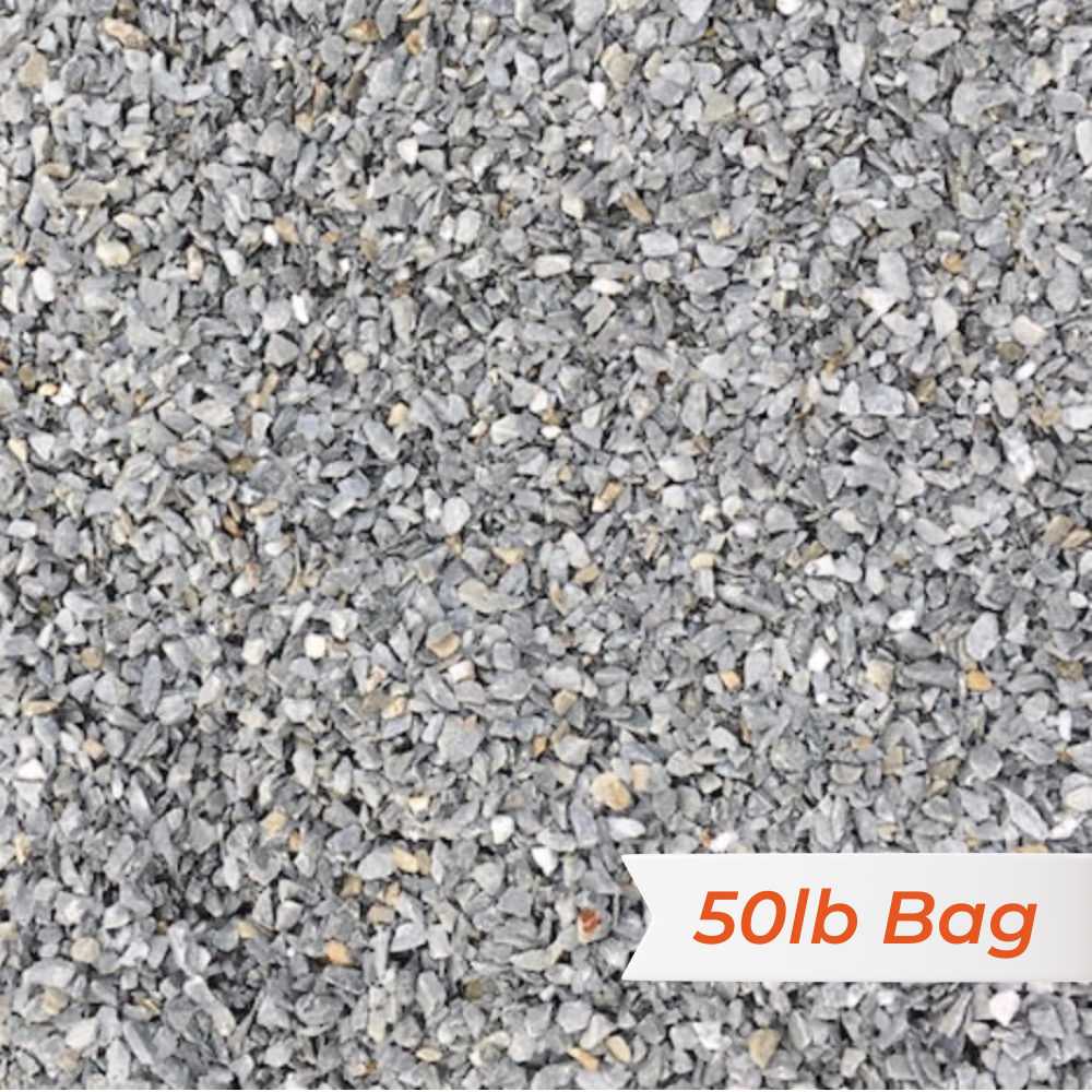 Close-up of gray gravel with a '50lb Bag' label in the corner.